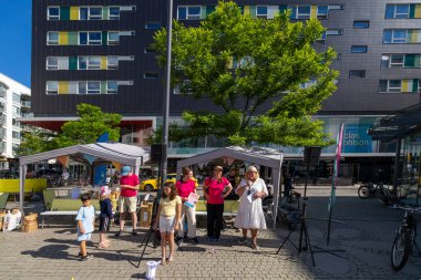 Stockholm, Sweden June 24, 2024 Representatives from the local mall and the city of Stockholm innaugurate  a community block party in the Liljeholmen district. clipart