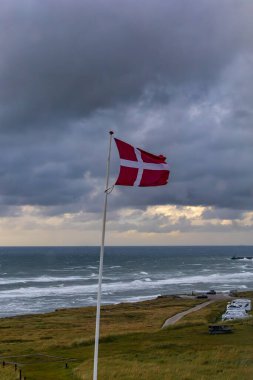 Hirtshals, Denmark July 5, 2024 A Danish flag flies on a flagpole next to the Hirtshals camping place.