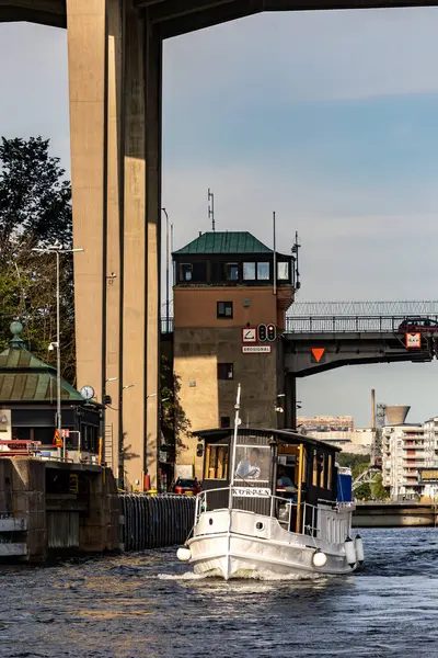 stock image Stockholm, Sweden July 26, 2024 Korpen, a  small riverboat, in the hammarby Slussen Lock system between Lake Malaren and the Baltic Sea.