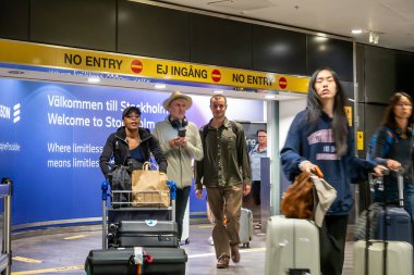 Stockholm, Sweden Aug 6, 2024 A young man walks through customs at the arrivals area at Arlanda Airport. clipart