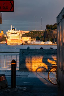 Stockholm, Sweden Aug 16, 2024 A bicylist on a bike path in thr Sussen district and the Stockholm harbor. clipart