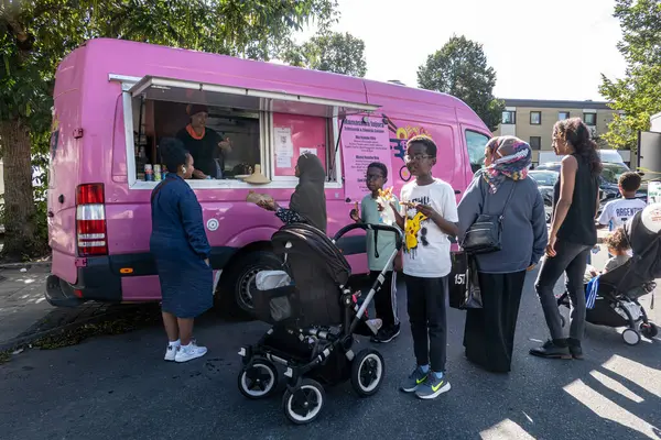 stock image Stockholm, Sweden Aug. 24, 2024  People in line at a food truck  enjoying the outdoor summer Rinkeby festival in the Rinkeby suburb.