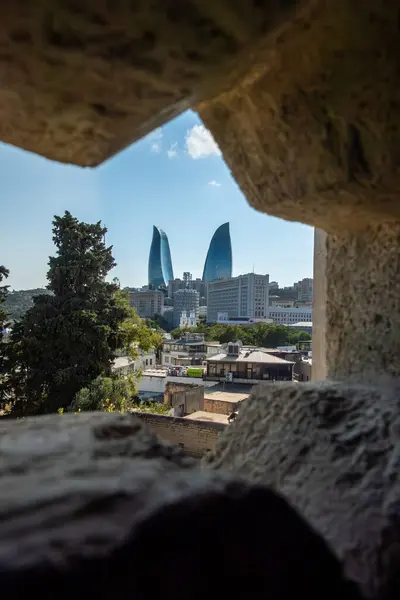 stock image Baku, Azerbaijan A view of the twin Flame Towers through a defensive hole in the old city wall.