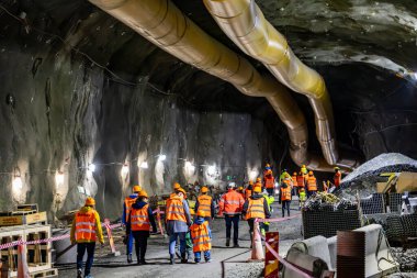 Stockholm, İsveç 13 Ekim 2024 Kasabanın merkezindeki Hammarbybacken 'de devam eden atık su arıtma tesisini ziyaret eden insanlar.