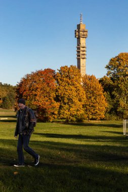 Stockholm, Sweden Oct 17, 2024  A man walks past the  Kaknas TV tower in the Gardet district. clipart