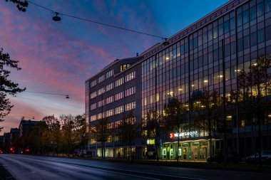 Stockholm, İsveç 24 Ekim 2024 Sonbahar şafağı Sodermalm 'deki Halka Vadisi yolu ve yükselen güneş ve gökyüzünün yansıması..