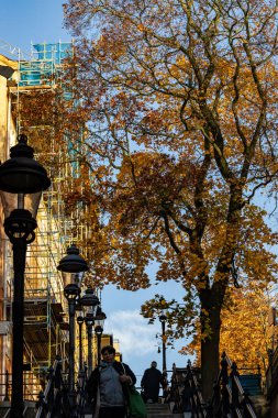 Stockholm, Sweden Oct 29, 2024 People walk on landmark steps on Kvarngatan in the Sodermalm district. clipart