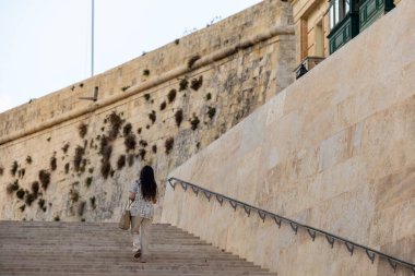 Valletta, Malta No: 4, 2024 Şehir Kapısı 'nda bir kadın tek başına yürüyor..