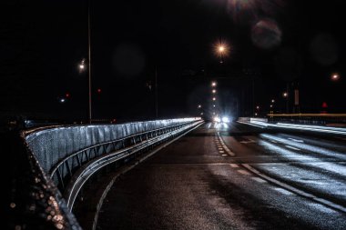 Stockholm, Sweden Traffic at night on the Liljeholmen bridge and reflecting headlights. clipart