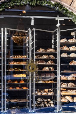 Uppsala, Sweden Nov 22, 2024 The window of the landmark Guntherska  bakery and loaves of bread on trays. clipart