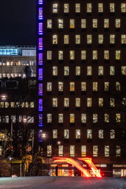 Stockholm, Sweden Nov 27, 2024 A view at night of buildings in the Marieberg district in the Kungsholmen neighbourhood and traffic streaks. . clipart