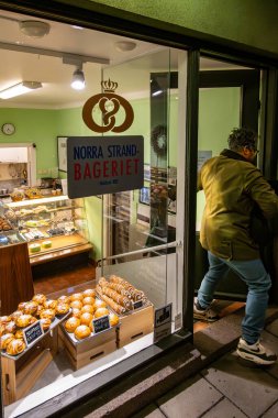 Stockholm, Sweden Nov 27, 2024 A customer exits the little Norra Strand bakery in the early morning, clipart