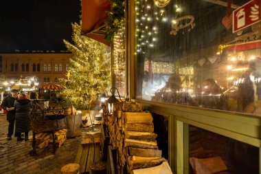 Riga, Latvia Dec 9, 2024 The foggy window of a warm cafe at the annual Christmas market. clipart