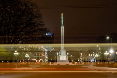 Riga, Letonya 10 Aralık 2024 Eski Şehir 'de gece tramvayı Özgürlük Anıtı' ndan geçer..