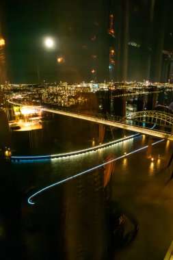 Stockholm, Sweden A window view with interior reflections of the Arsta train bridge from a Sky Bar in Liljeholmskajen. clipart