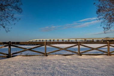 Solomons, Maryland, USA A view of the Gov. Thomas Johnson Bridge in the snow in winter on the Patuxent River. clipart