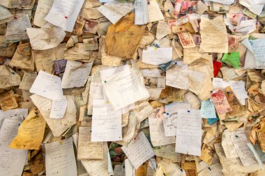 Cairo, Egypt, A board is filled with paper notes, messages and scribllings and mementos. clipart