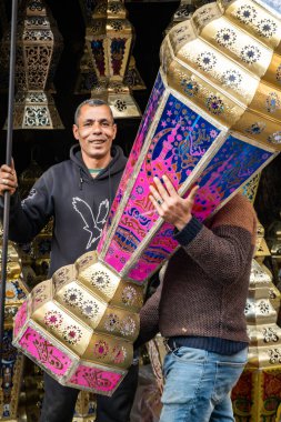 Cairo, Egypt, Jan 25, 2025 Pedestrians walk by an ornate lantern shop in the big Khan el-Khalili Cairo bazaar. clipart