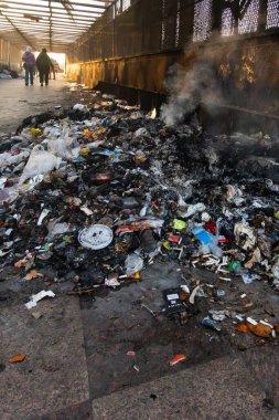 Cairo, Egypt Jan 26, 2025 Piles of burning garbage on an overpass the Shubra Metro station  north of the city. clipart