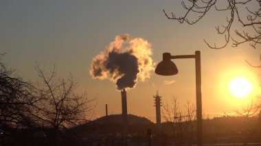 Stockholm, İsveç Sabahın erken saatlerinde şehrin güney kesimine buhar salan büyük bir ısıtma tesisi bacası manzarası.