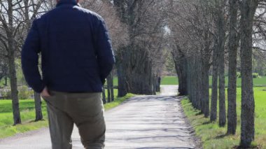 Eskilstuna, İsveç Baharda ağaçlık bir sokakta bir adam yürüyor. 