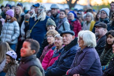 Stockholm, İsveç 30 Nisan 2025 'te kalabalık konuşmaları dinlemek ve Walpurgis gecesini kutlamak için halka açık bir parkta büyük bir şenlik ateşi seyretmek için toplandı..