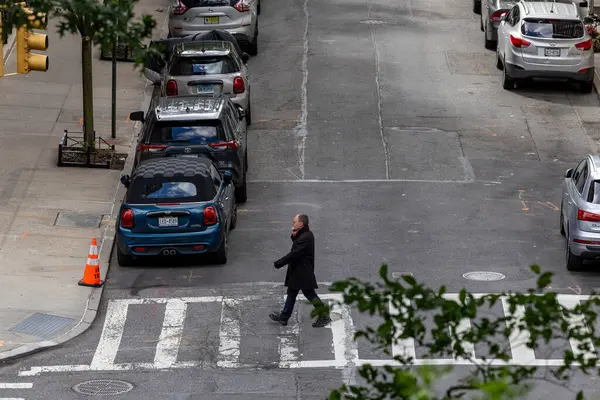 New York, New York, ABD Mayıs 2025 Yukarı Batı Yakası 'ndaki 8. sokakta yaya bir adam karşıdan karşıya geçiyor..