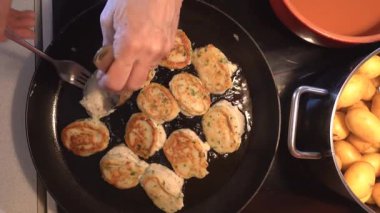 Hirtshals Danimarka usulü balık kızartma makinesi veya balık köftesi, bir Danimarka yemeği spesiyali, tavada kızartılıyor..