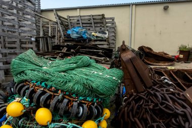 Hirtshals, Denmark Folded fishing nets in the harbor and chains.