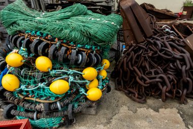 Hirtshals, Denmark Folded fishing nets in the harbor and chains.
