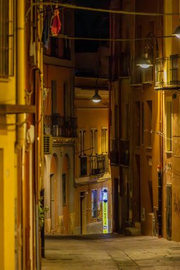 Cagliari, Sardinya, İtalya 10 Ağustos 2025. Geceleri boş bir yaya caddesinde berber tabelası..