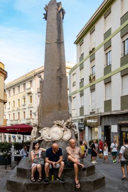 Cagliari, Sardunya, İtalya 13 Ağustos 2025 Piazza Martiri D 'Italia' da oturan insanlar, tarihi şehir merkezindeki bir şehit anıtı..