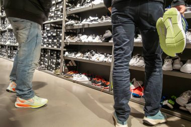 Stockholm, İsveç 27 Eylül 2025 Erkek ayakkabı mağazasında spor ayakkabısı arıyor.