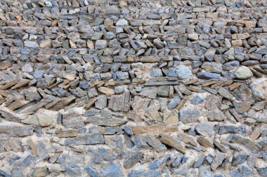Rock wall in a villag, closeup of photo