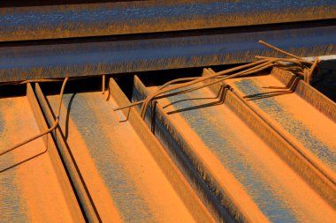steel plate banding piled up together, closeup of photo