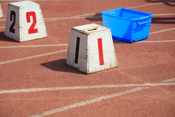 Kırmızı plastik pistteki parça numarası