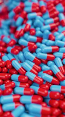 Kırmızı ve mavi haplar yavaş çekimde ve sığ DOF ile karıştırılıyor. İlaçlar, haplar, haplar, ilaç konsepti. 3D canlandırma canlandırması. Dikey video.