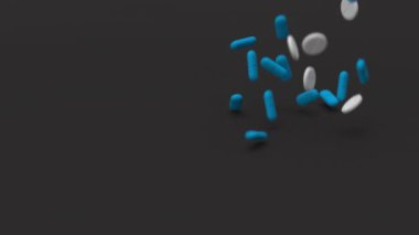 Mavi ve beyaz tabletler yavaş çekimde siyah arka plana düşüyor. İlaçlar, haplar, haplar, ilaç konsepti. 3d canlandırma canlandırması.