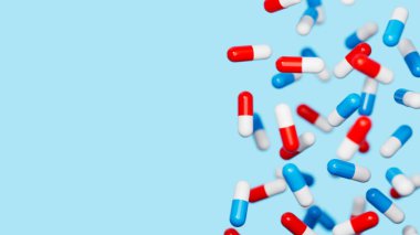 Mavi kırmızı beyaz ilaç kapsülleri mavi arkaplan ve yazı için bir yer. Tıbbi araştırma, bilim konsepti. 3d resimleme.