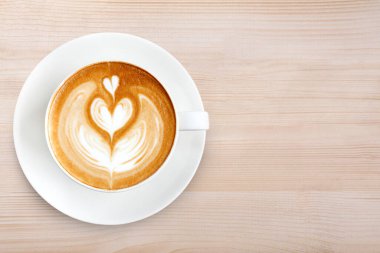 Üstten Görünüm latte sanat ahşap arka plan üzerinde kahve