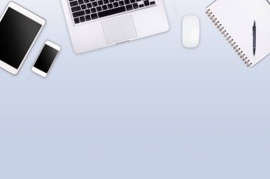 Laptop tabletli modern çalışma alanı ve renkli arka planda akıllı telefon kopyalama alanı. Üst Manzara. Düzleştirme biçimi.