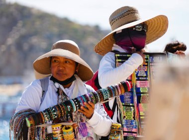 Cabo San Lucas, Meksika - 7 Kasım 2022 Plajda renkli mücevherler satan yerel bir satıcı