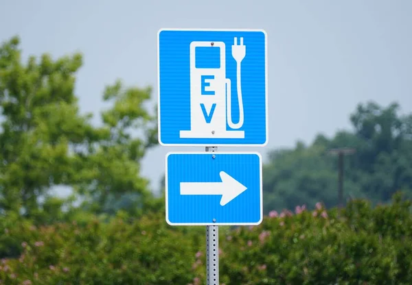 stock image Rehoboth Beach, Delaware, U.S.A - June 18, 2023 - The blue and white EV sign for the charging station for electric vehicles