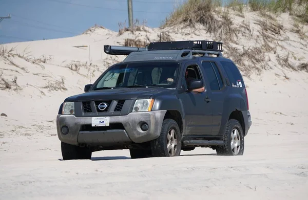 stock image Savage Ditch, Delaware, U.S.A - July 4, 2023 - A black hatchback Subaru with surf fishing beach permit