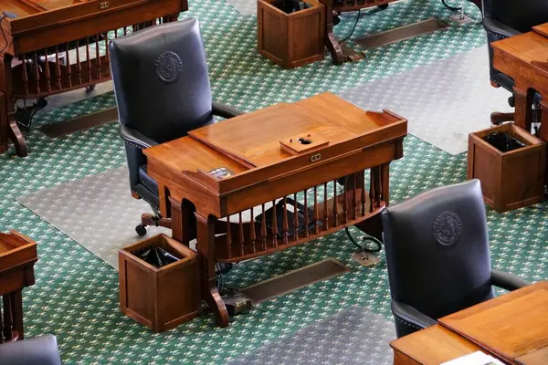 stock image Austin, Texas, U.S.A - April 9, 2024 - Closeup of the leather seat and the wooden table in the Senate Chamber of the Texas Capitol