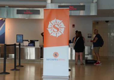 Essington, Pennsylvania, U.S.A - July 9, 2024 - The Sun Country Airlines check-in counters at Philadelphia International Airport clipart