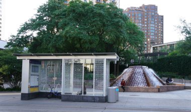 Minneapolis, Minnesota, U.S.A - July 13, 2024 - The bus stop and the waterfall at the south end of Nicollet Mall and Loring Greenway clipart