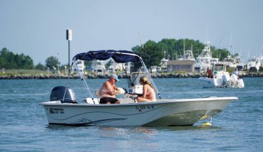 Bethany Beach, Delaware, U.S.A - August 6, 2024 - Anglers on the pontoon boat fishing for flounder near Indian River Inlet in the summer clipart