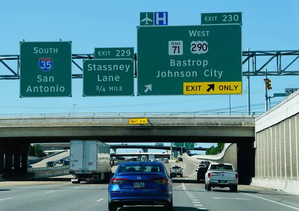 stock image Texas, U.S.A - April 6, 2024 - Traffic on the highway with sign to I-35 South, exit 229 into Stassney Lane, 290 West and Texas 71 West