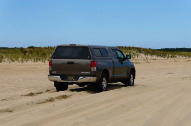 Rehoboth Beach, Delaware, ABD - 2 Eylül 2024 Kumlu sahilde bir Toyota Tundra 4X4 kamyonu